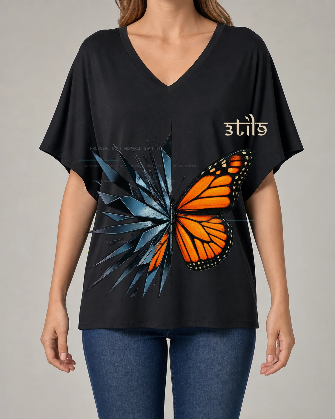 Woman wearing a black bat-sleeve V-neck blouse with the orange and blue-black Monarch Shattered artwork